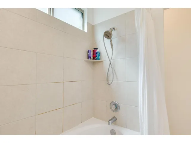 a bathroom with a shower and a shower