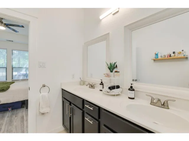 a bathroom with a double vanity sink and a mirror