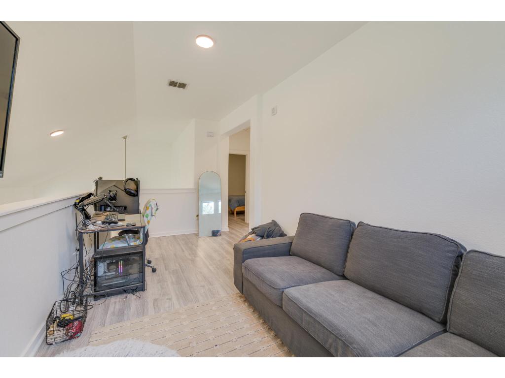 2001 Faro Drive, Unit 53 Austin, TX 78741 - Photo 25 of 34 a living room with furniture and a flat screen tv