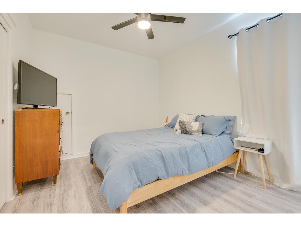 2001 Faro Drive, Unit 53 Austin, TX 78741 - Photo 26 of 34 a bedroom with a bed and wooden floor