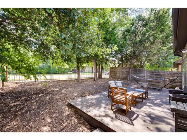 a backyard of a house with table and chairs