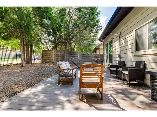a backyard of a house with barbeque oven and outdoor seating