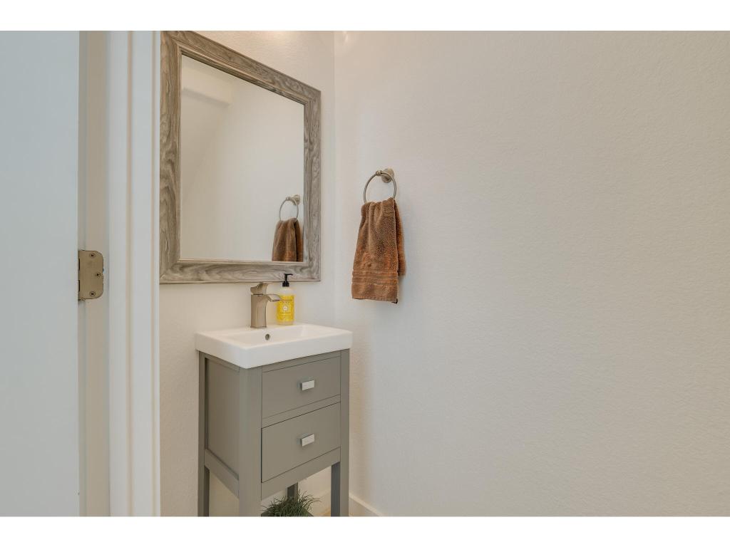 2001 Faro Drive, Unit 53 Austin, TX 78741 - Photo 7 of 34 a bathroom with a sink vanity and mirror