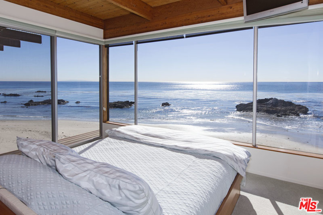 24958 Malibu Road Malibu, CA 90265 - Photo 30 of 50 a bedroom with a bed and large window