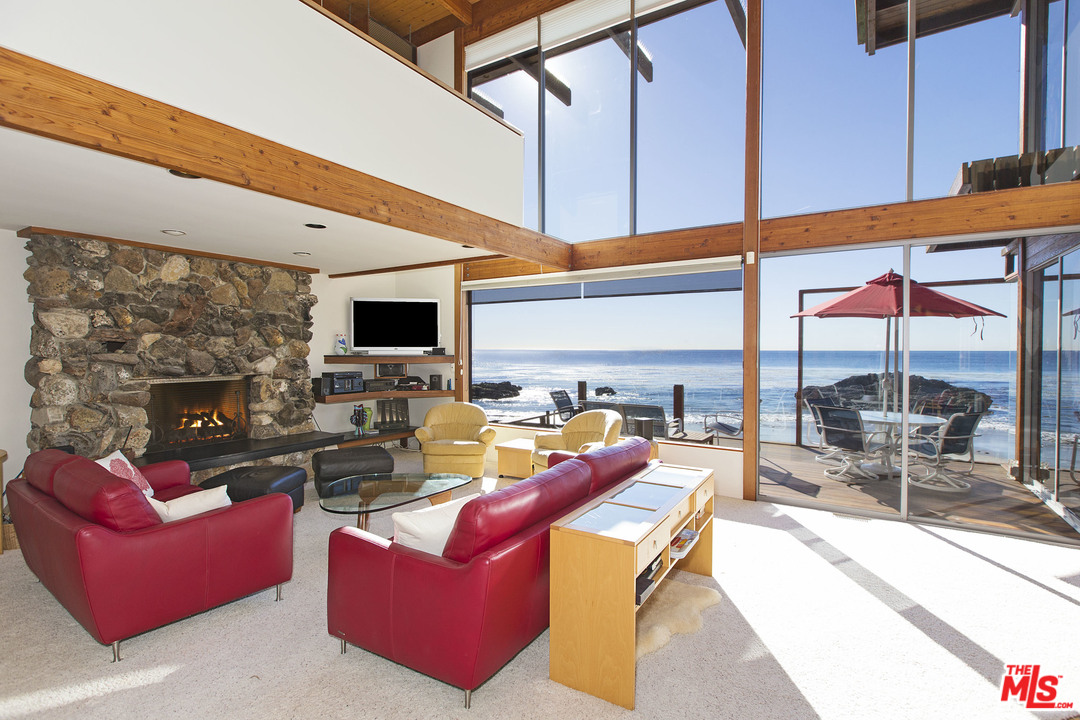 24958 Malibu Road Malibu, CA 90265 - Photo 4 of 50 a living room with fireplace furniture and a flat screen tv
