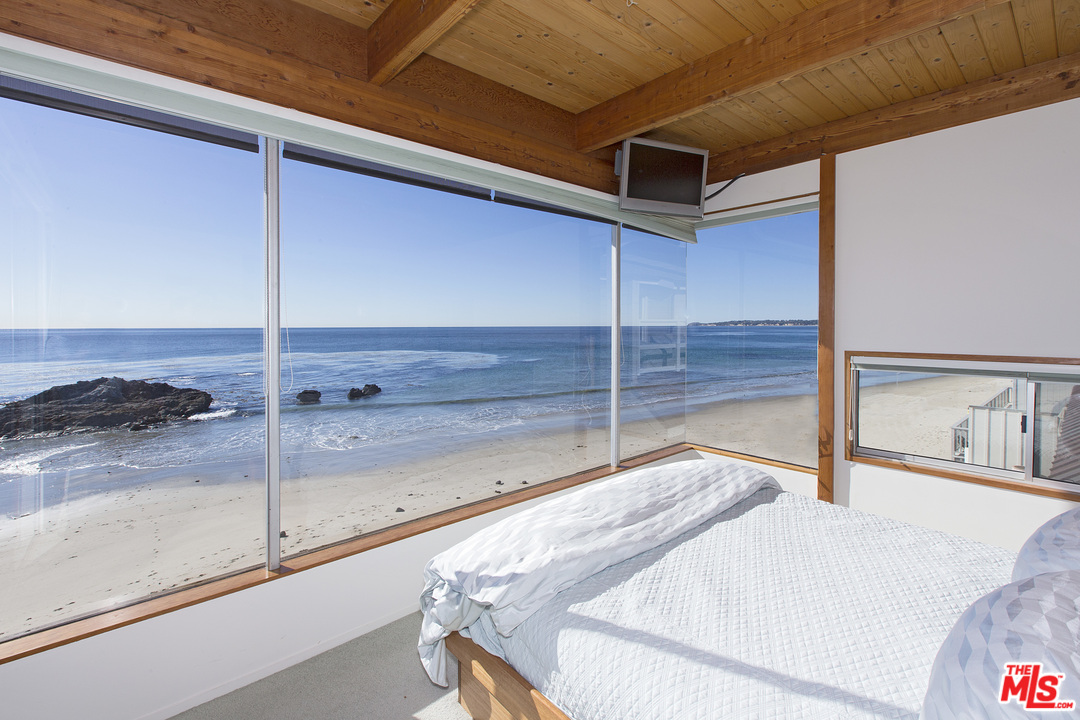24958 Malibu Road Malibu, CA 90265 - Photo 32 of 50 a room with a balcony and glass door