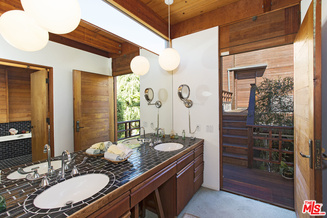 24958 Malibu Road Malibu, CA 90265 - Photo 33 of 50 a bathroom with a granite countertop sink and a mirror