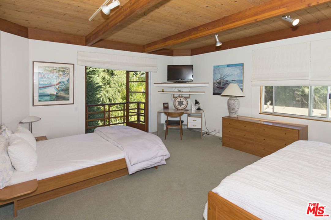 24958 Malibu Road Malibu, CA 90265 - Photo 37 of 50 a bedroom with a bed and a large window
