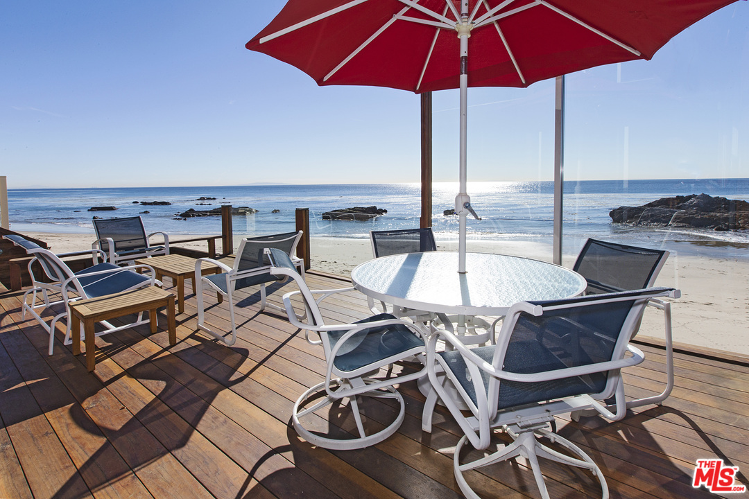 24958 Malibu Road Malibu, CA 90265 - Photo 10 of 50 a view of a patio with chairs under an umbrella