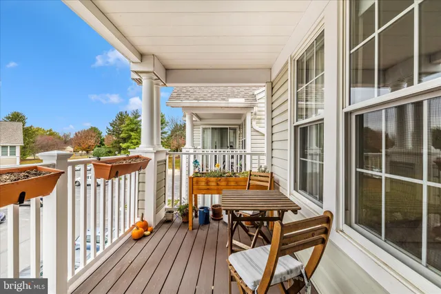 a view of a balcony with two chairs and wooden floor