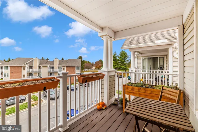 a view of deck with table and chairs and wooden floor