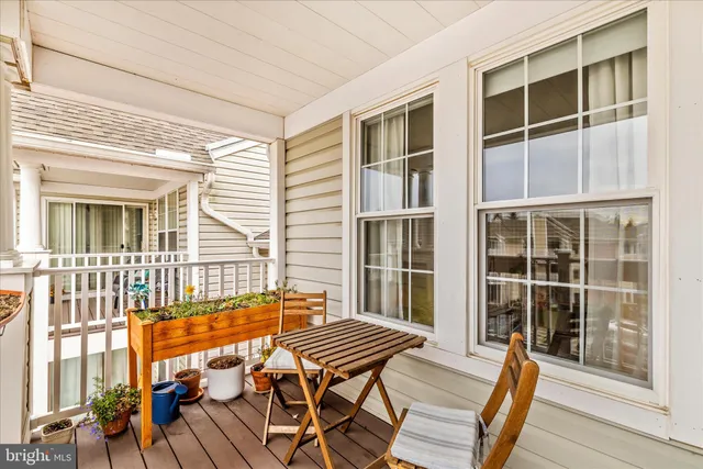 a view of a balcony with wooden floor and fence