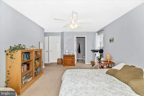 a kitchen with stainless steel appliances granite countertop a refrigerator a sink dishwasher and wooden cabinets with wooden floor