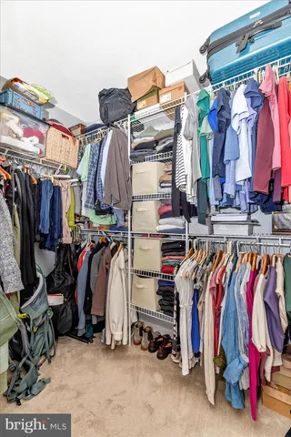 a front view of a building with cars parked