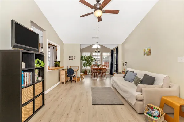 a kitchen with stainless steel appliances granite countertop a stove a sink dishwasher and a refrigerator with wooden floor