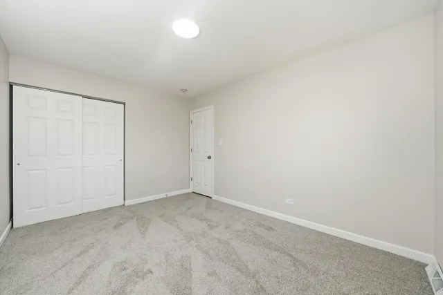 an empty room with a painting on the wall