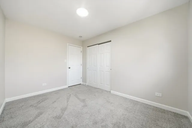 an empty room with a painting on the wall