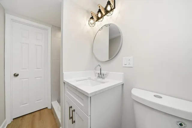 a white toilet sitting next to a white sink