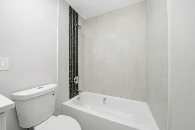 an empty room with a painting on the wall