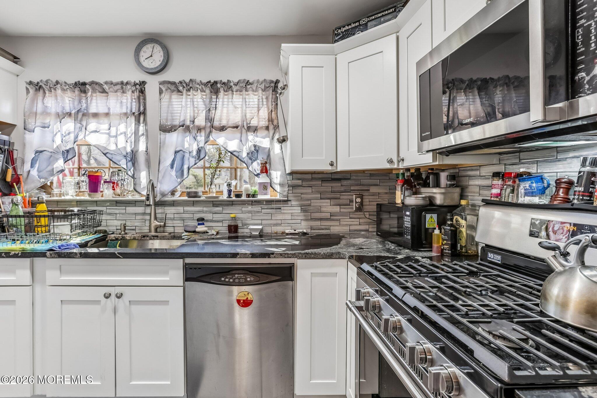 197 Azalea Circle Jackson, NJ 08527 - Photo 15 of 33 a kitchen with stainless steel appliances granite countertop a stove and cabinets