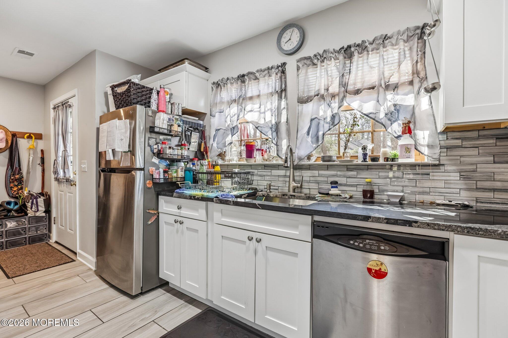 197 Azalea Circle Jackson, NJ 08527 - Photo 16 of 33 a kitchen with stainless steel appliances granite countertop a refrigerator and a sink