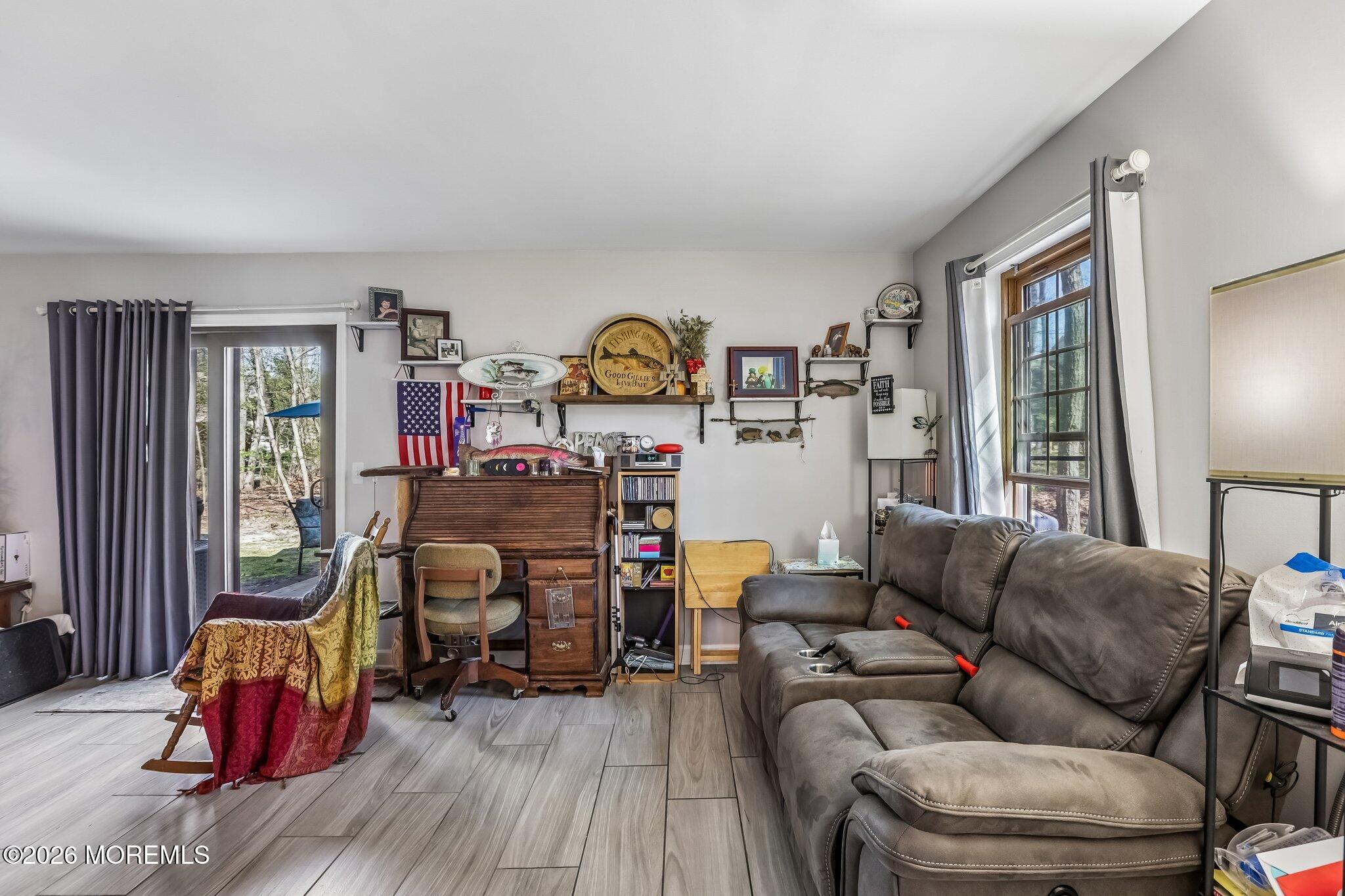 197 Azalea Circle Jackson, NJ 08527 - Photo 21 of 33 a living room with furniture and a wooden floor
