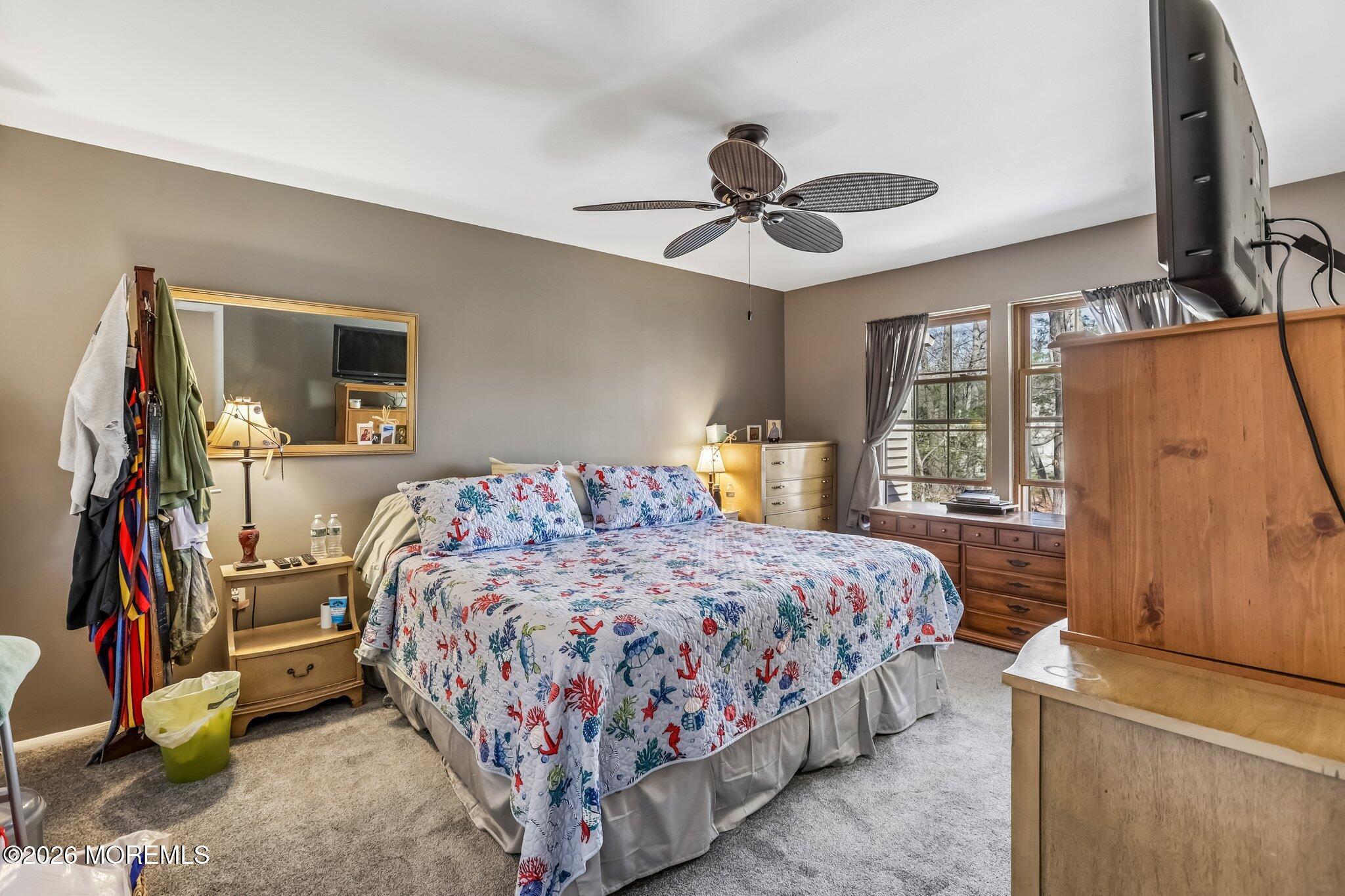 197 Azalea Circle Jackson, NJ 08527 - Photo 28 of 33 a bedroom with a bed and a flat tv screen on dresser