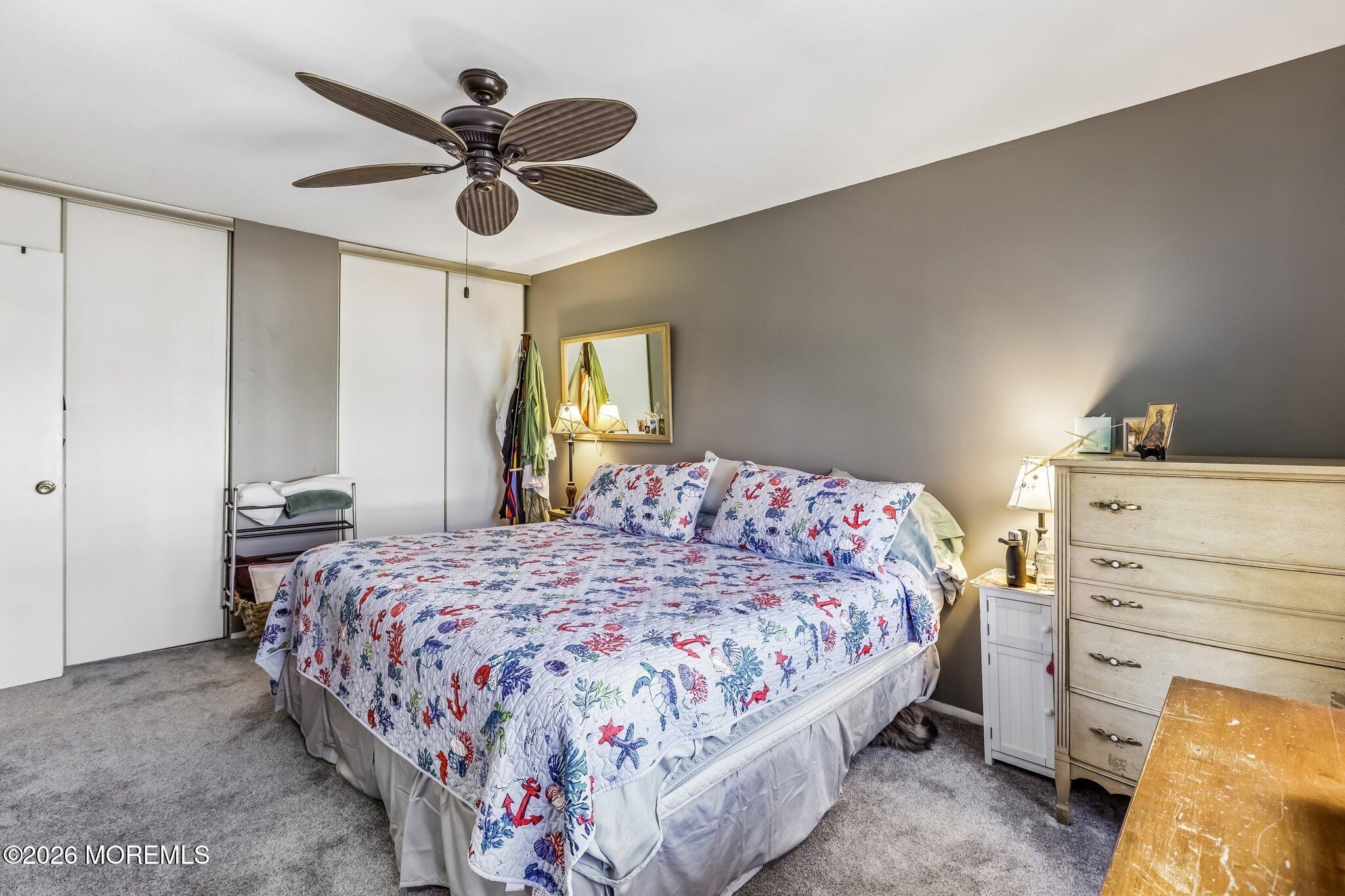197 Azalea Circle Jackson, NJ 08527 - Photo 29 of 33 a bedroom with a bed and a chandelier