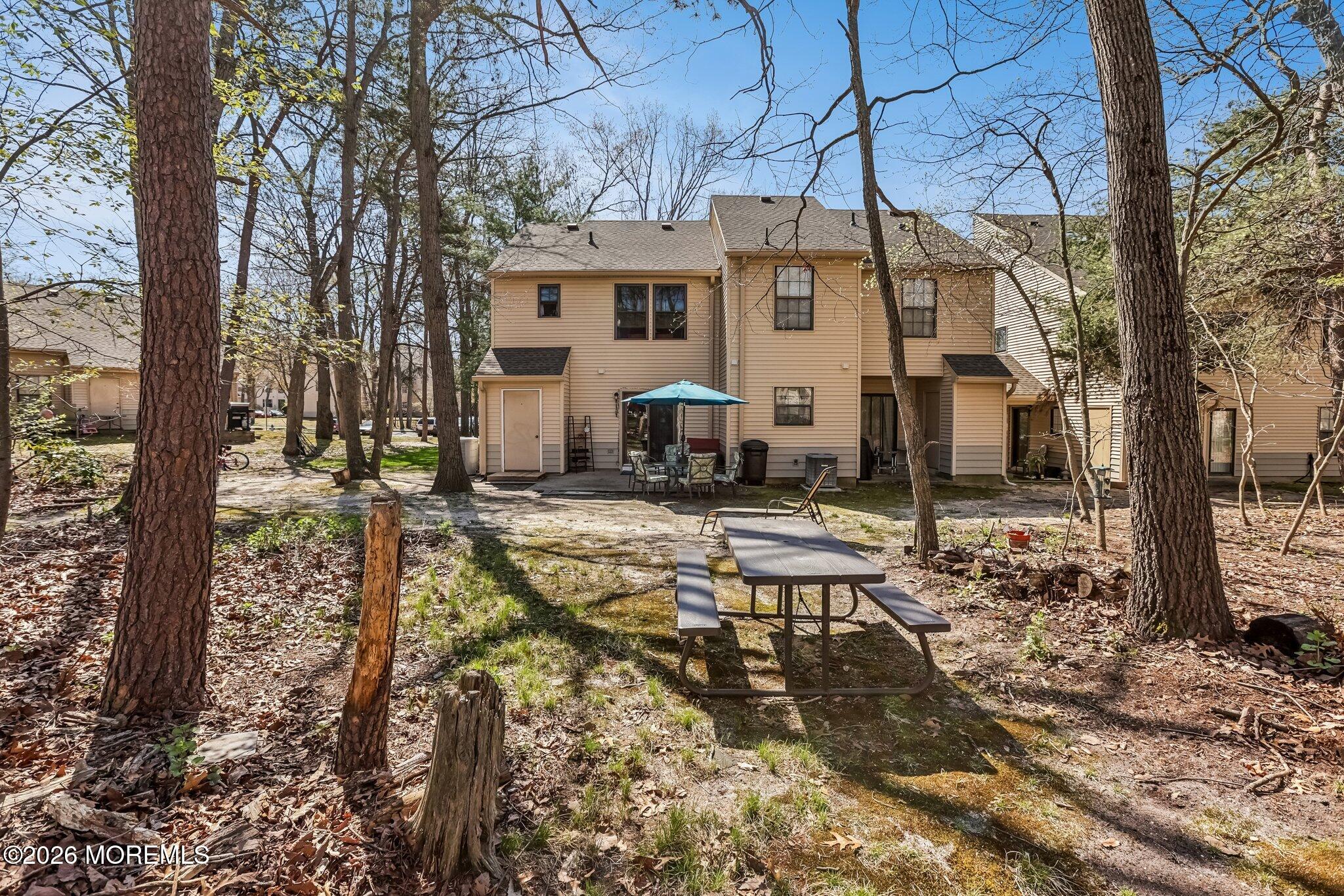 197 Azalea Circle Jackson, NJ 08527 - Photo 10 of 33 a view of a white house next to a yard with wooden fence