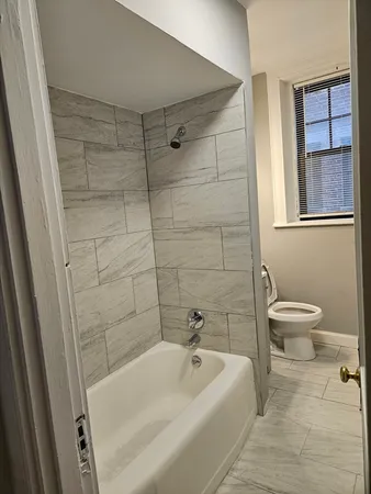 a bathroom with a bathtub and toilet