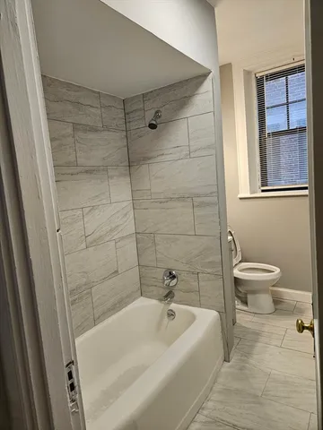 a bathroom with a bathtub and toilet