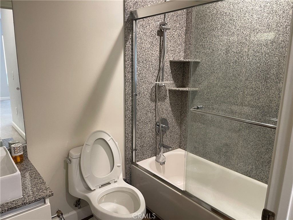 28 North 3rd Street, Unit B210 Alhambra, CA 91801 - Photo 4 of 9 a bathroom with a granite countertop bathtub shower sink vanity and toilet