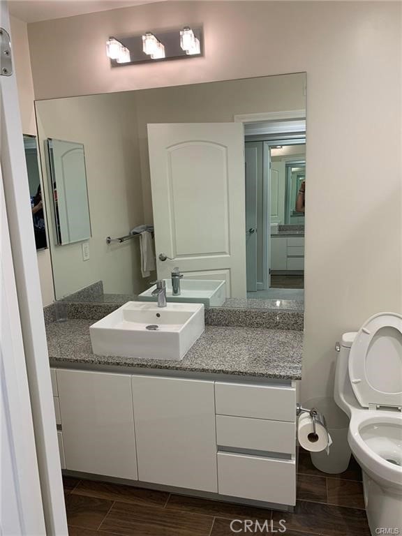 28 North 3rd Street, Unit B210 Alhambra, CA 91801 - Photo 6 of 9 a bathroom with a granite countertop toilet sink and mirror