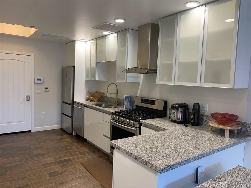 28 North 3rd Street, Unit B210 Alhambra, CA 91801 - Photo 8 of 9 a kitchen with granite countertop a sink a stove and cabinets