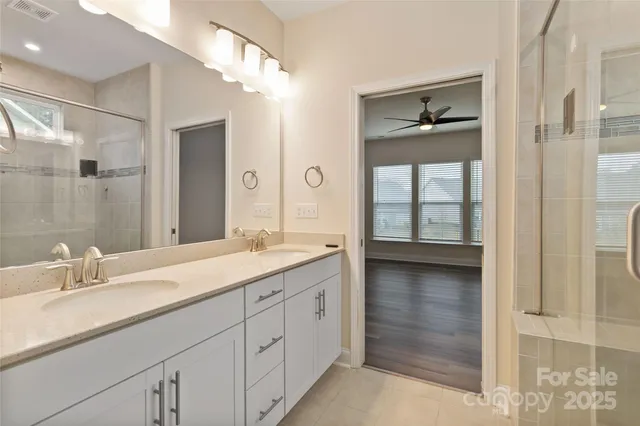 a bathroom with a double vanity sink and a mirror