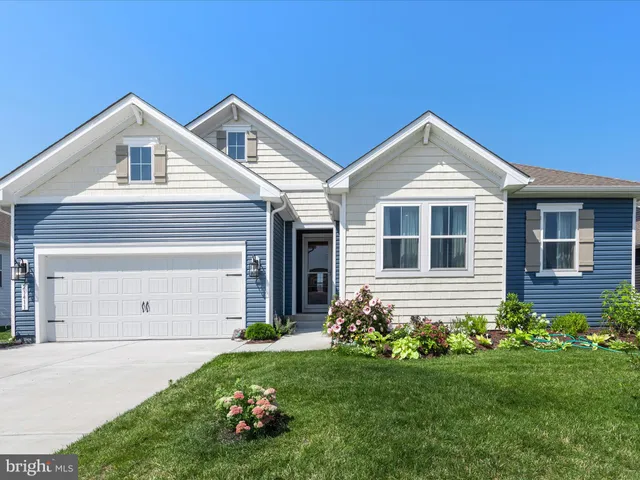 a kitchen with granite countertop a stove and white cabinets