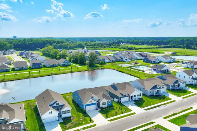 a kitchen with granite countertop white cabinets and stainless steel appliances