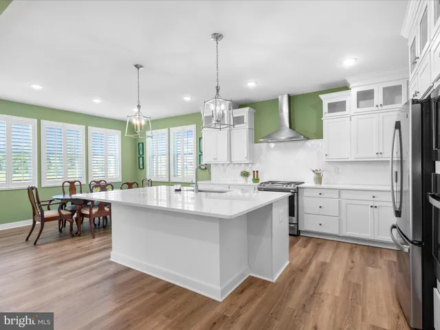 a kitchen with stainless steel appliances a sink stove and refrigerator