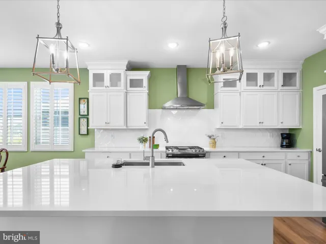 a bedroom with a bed and a dresser with mirror