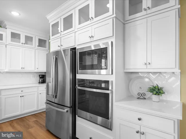 a view of a house with a yard and potted plants