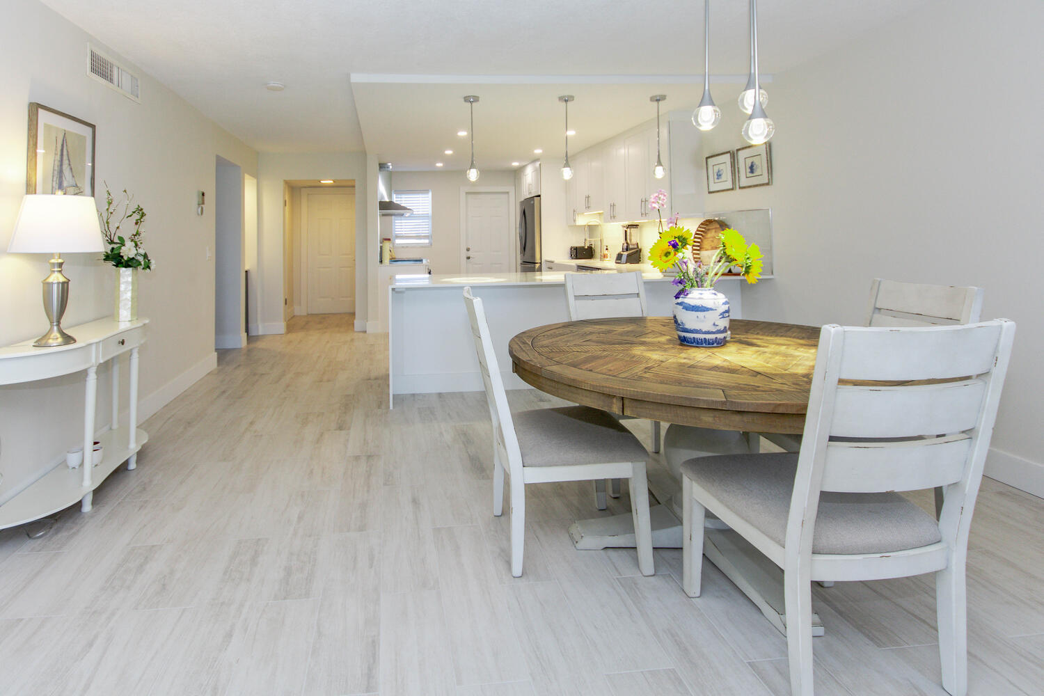 120 Celestial Way, Unit 302 Juno Beach, FL 33408 - Photo 13 of 55 a dining room with furniture and a chandelier