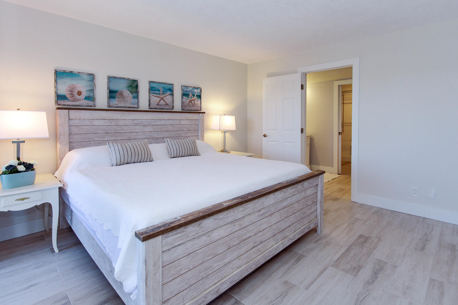 120 Celestial Way, Unit 302 Juno Beach, FL 33408 - Photo 19 of 55 a bedroom with a bed and a night stand