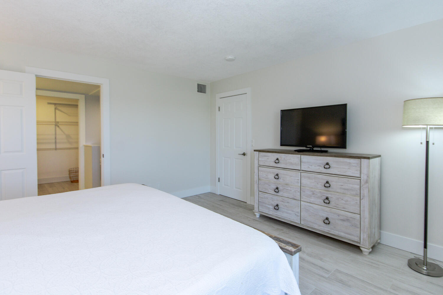 120 Celestial Way, Unit 302 Juno Beach, FL 33408 - Photo 21 of 55 a bedroom with a bed and a flat screen tv in it
