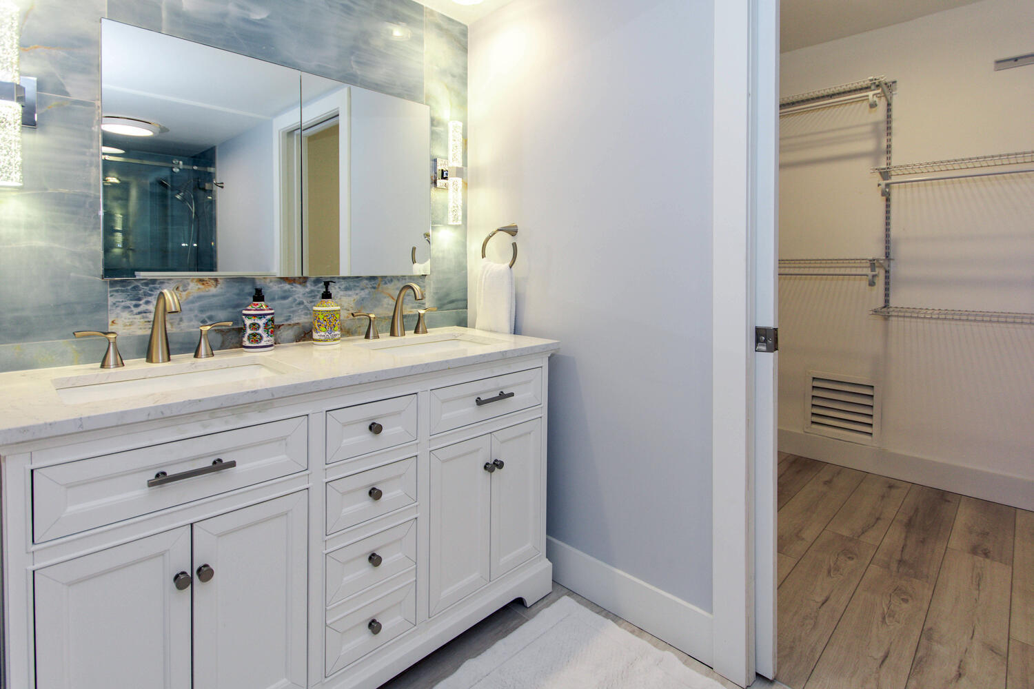 120 Celestial Way, Unit 302 Juno Beach, FL 33408 - Photo 25 of 55 a bathroom with a double vanity sink and mirror