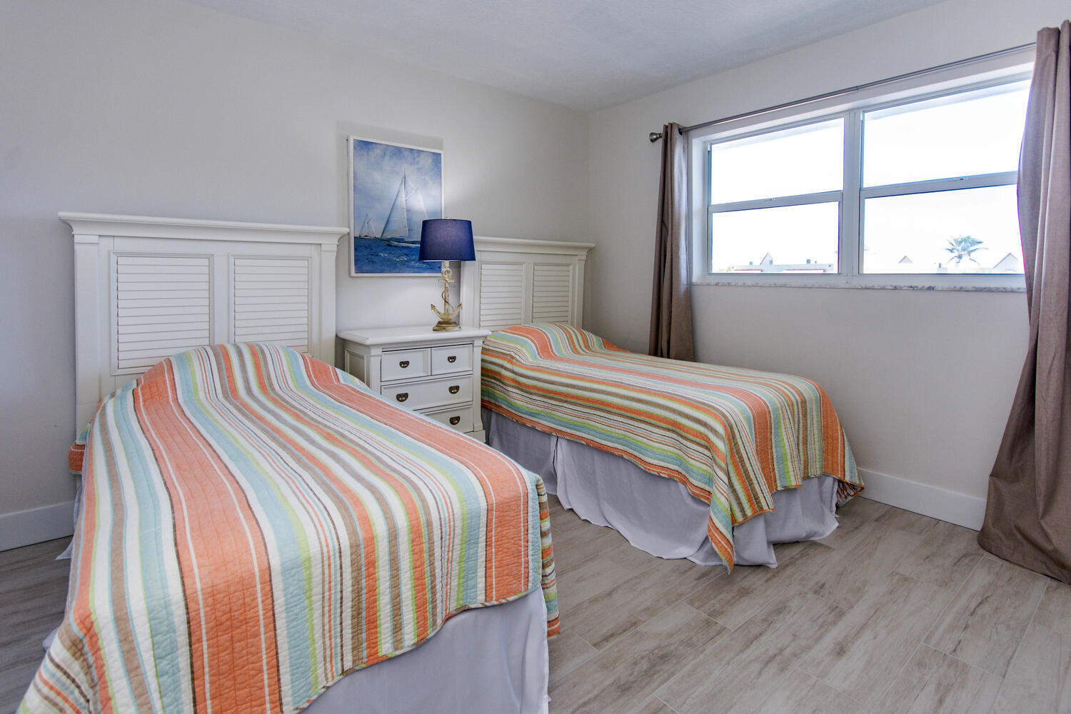 120 Celestial Way, Unit 302 Juno Beach, FL 33408 - Photo 37 of 55 a bedroom with two beds and a window