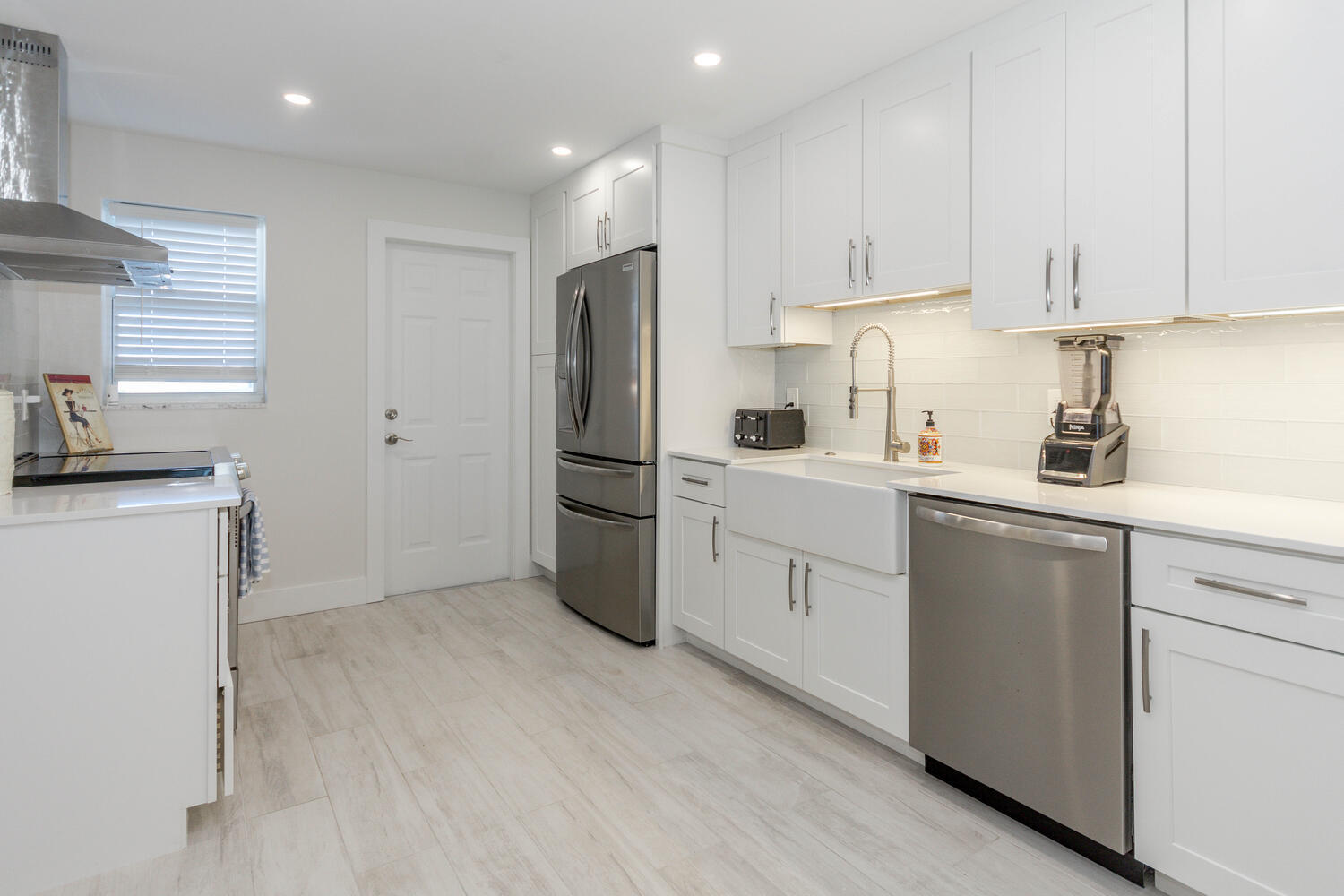 120 Celestial Way, Unit 302 Juno Beach, FL 33408 - Photo 8 of 55 a kitchen with white cabinets and white appliances