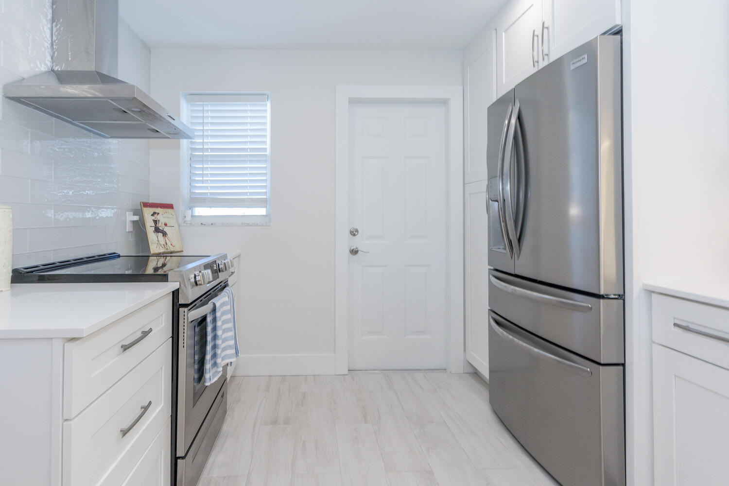 120 Celestial Way, Unit 302 Juno Beach, FL 33408 - Photo 9 of 55 a kitchen with stainless steel appliances granite countertop a refrigerator a stove and a sink