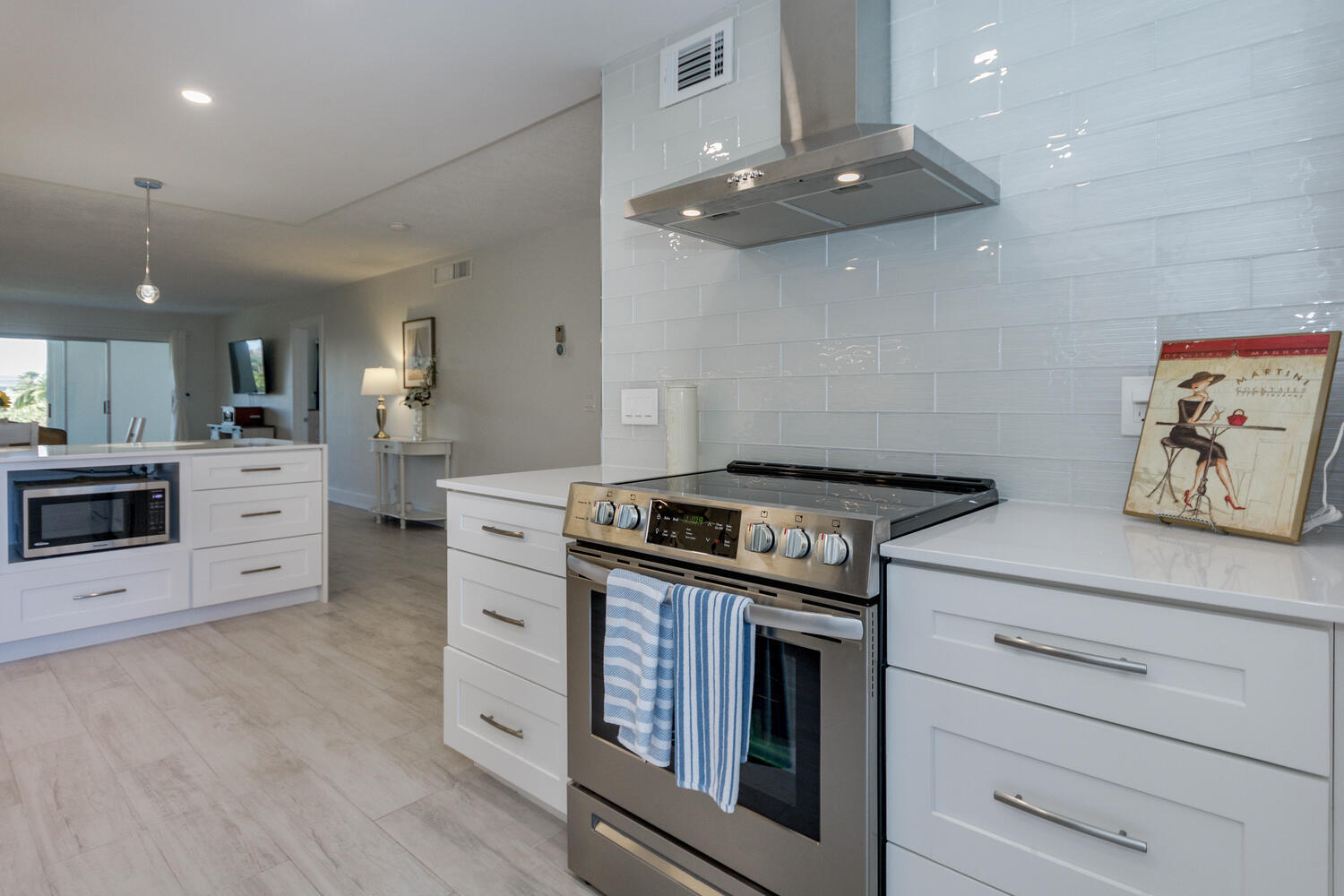 120 Celestial Way, Unit 302 Juno Beach, FL 33408 - Photo 10 of 55 a kitchen with a stove cabinets and wooden floor
