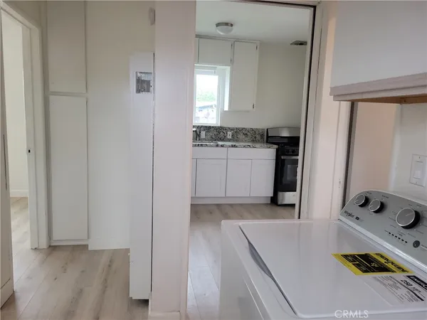 a kitchen with sink a refrigerator and cabinets