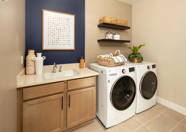 a bathroom with a sink a toilet a mirror and shower